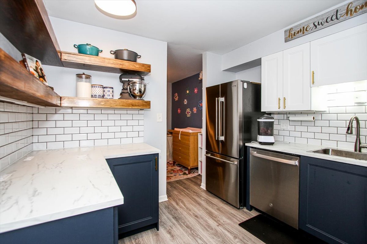 2300 Old Tavern Road, Unit 203 Lisle, IL 60532 - Photo 12 of 26 a kitchen with stainless steel appliances granite countertop a refrigerator a sink and wooden cabinets