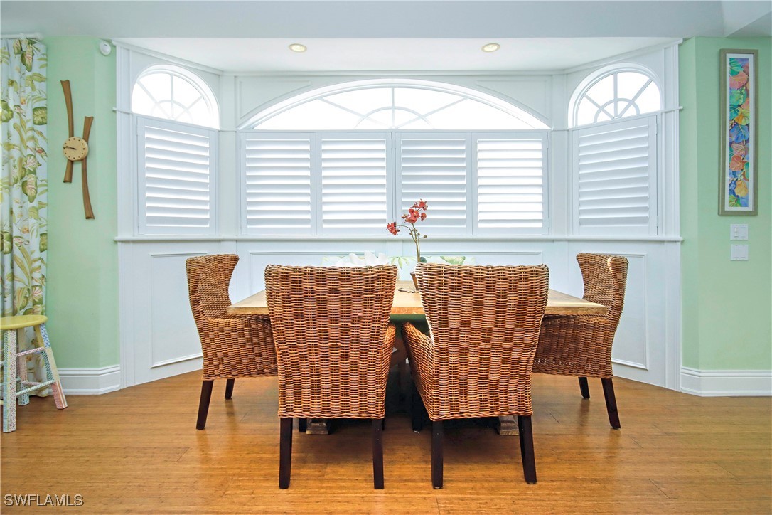 970 Victoria Way Sanibel, FL 33957 - Photo 8 of 36 a dining room with furniture and wooden floor