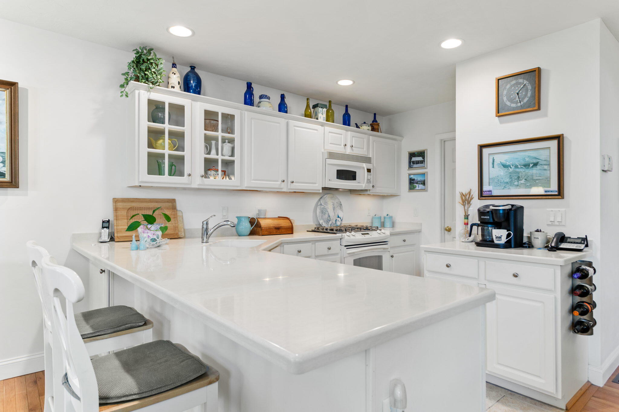 1 Prestwick Road Bourne, MA 02532 - Photo 11 of 32 a kitchen with a sink a stove and white cabinets