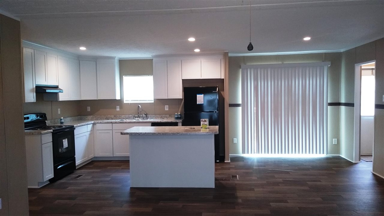 4224 Chicken George Trail Ripley, TN 38063 - Photo 3 of 8 a kitchen with a refrigerator and a stove top oven