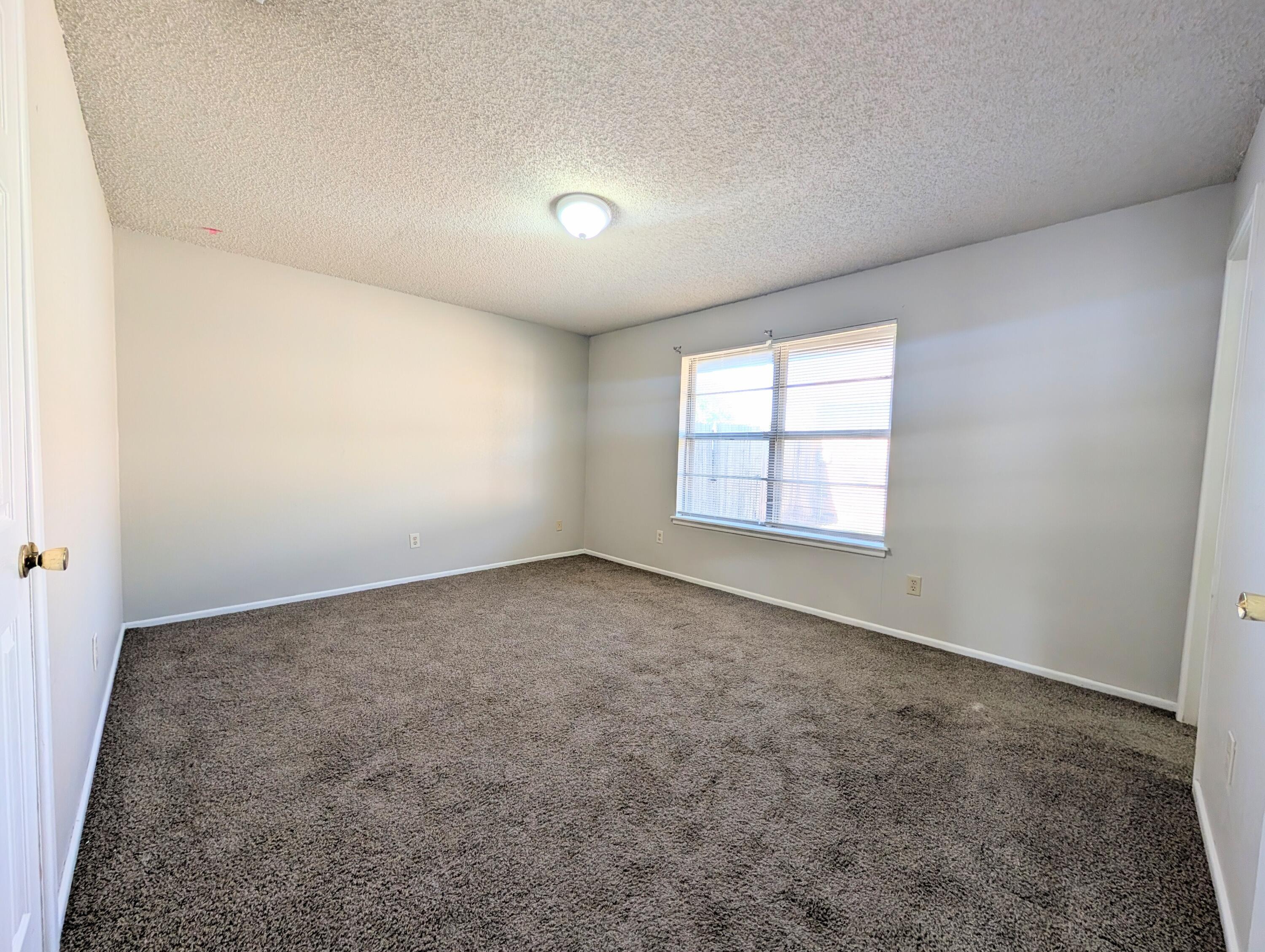 6509 21st Street, Unit B Lubbock, TX 79407 - Photo 8 of 9 an empty room with windows
