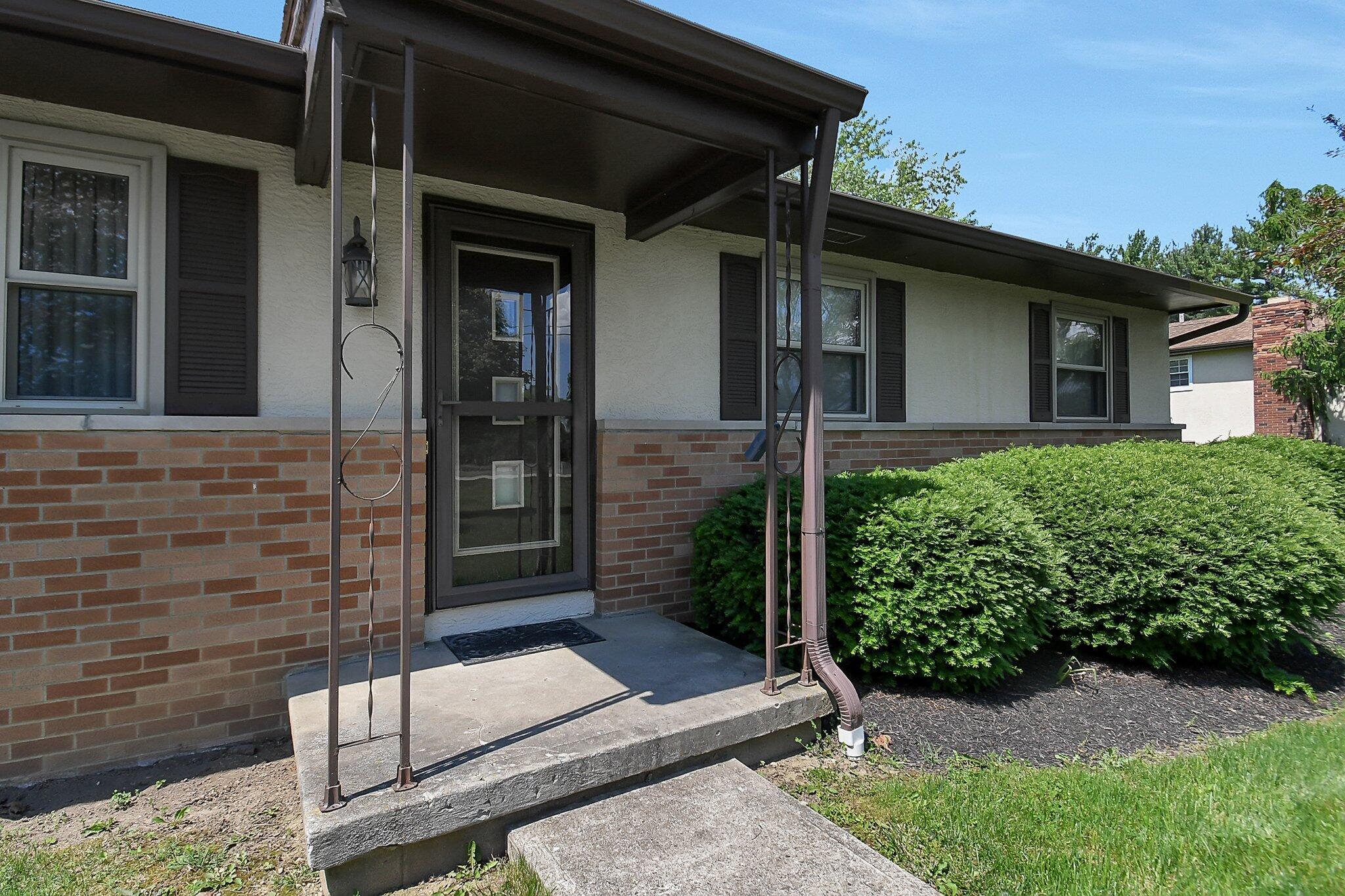 Full view storm with covered porch. Brick 1/2 front/succo