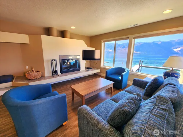 a living room with furniture a wooden floor and a large window
