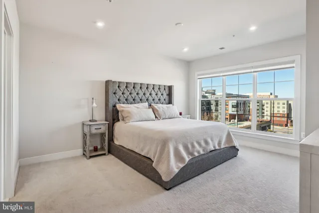 a large bed sitting in a room next to a large window