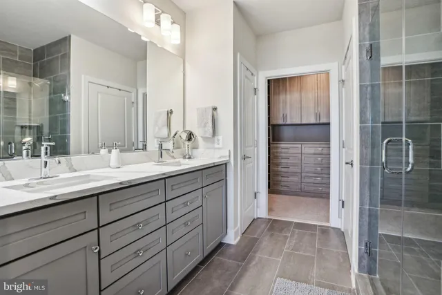 a bathroom with a shower sink and mirror