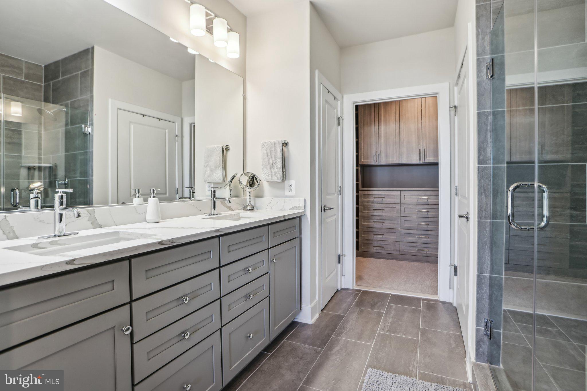 100 St Ives Place, Unit 306 Oxon Hill, MD 20745 - Photo 19 of 32 a bathroom with a shower sink and mirror