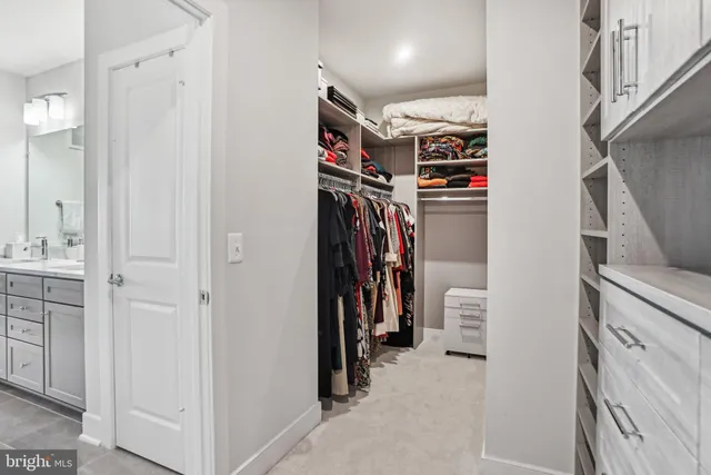 a view of walk in closet with clothes
