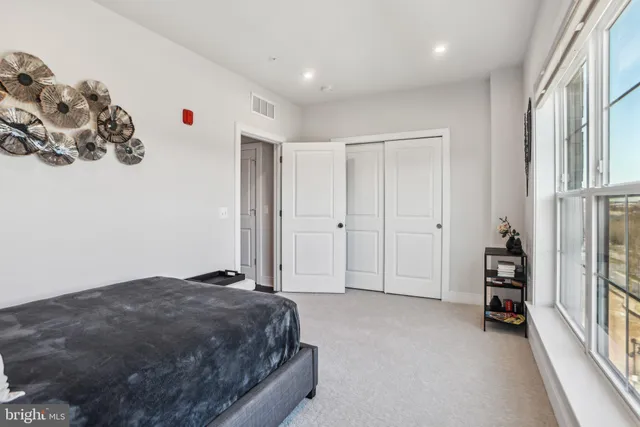 a spacious bedroom with a bed and a window