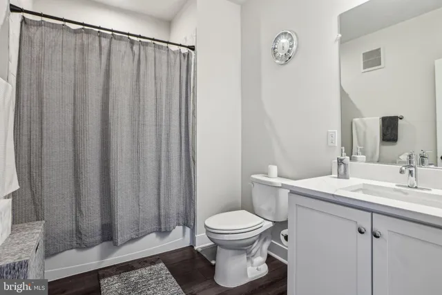 a bathroom with a toilet a sink and a mirror