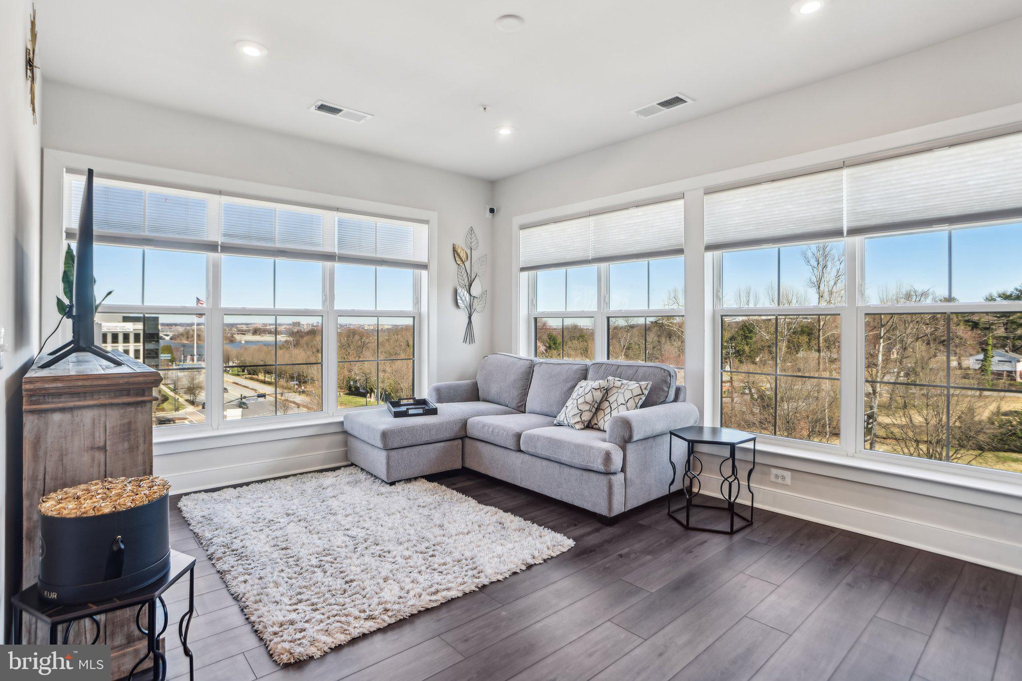 100 St Ives Place, Unit 306 Oxon Hill, MD 20745 - Photo 6 of 32 a living room with furniture and a large window