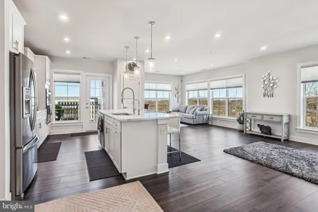 a open kitchen with white cabinets and stainless steel appliances