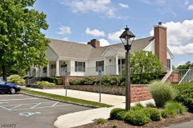 a front view of a house with a garden and plants