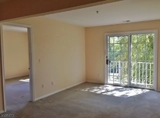 a view of empty room with floor to ceiling window