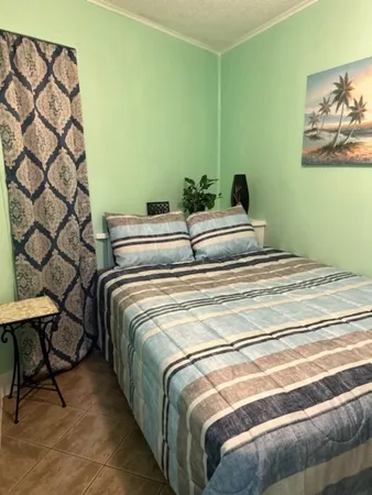 a bedroom with a bed and painting on the wall