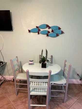 a dining room with furniture and wooden floor