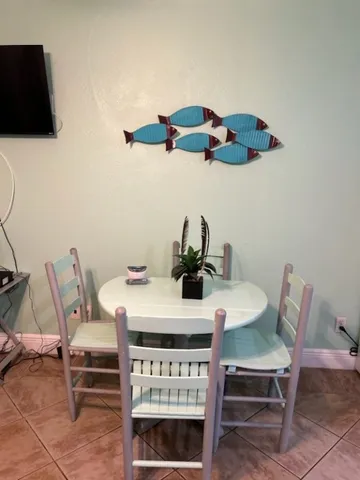 a dining room with furniture and wooden floor