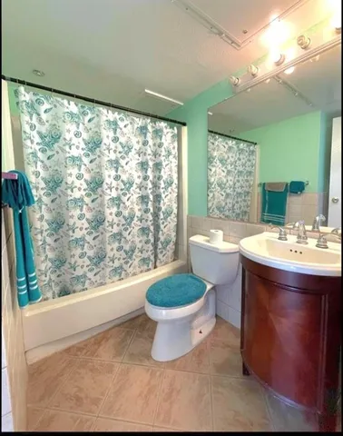 a bathroom with a sink toilet mirror and window