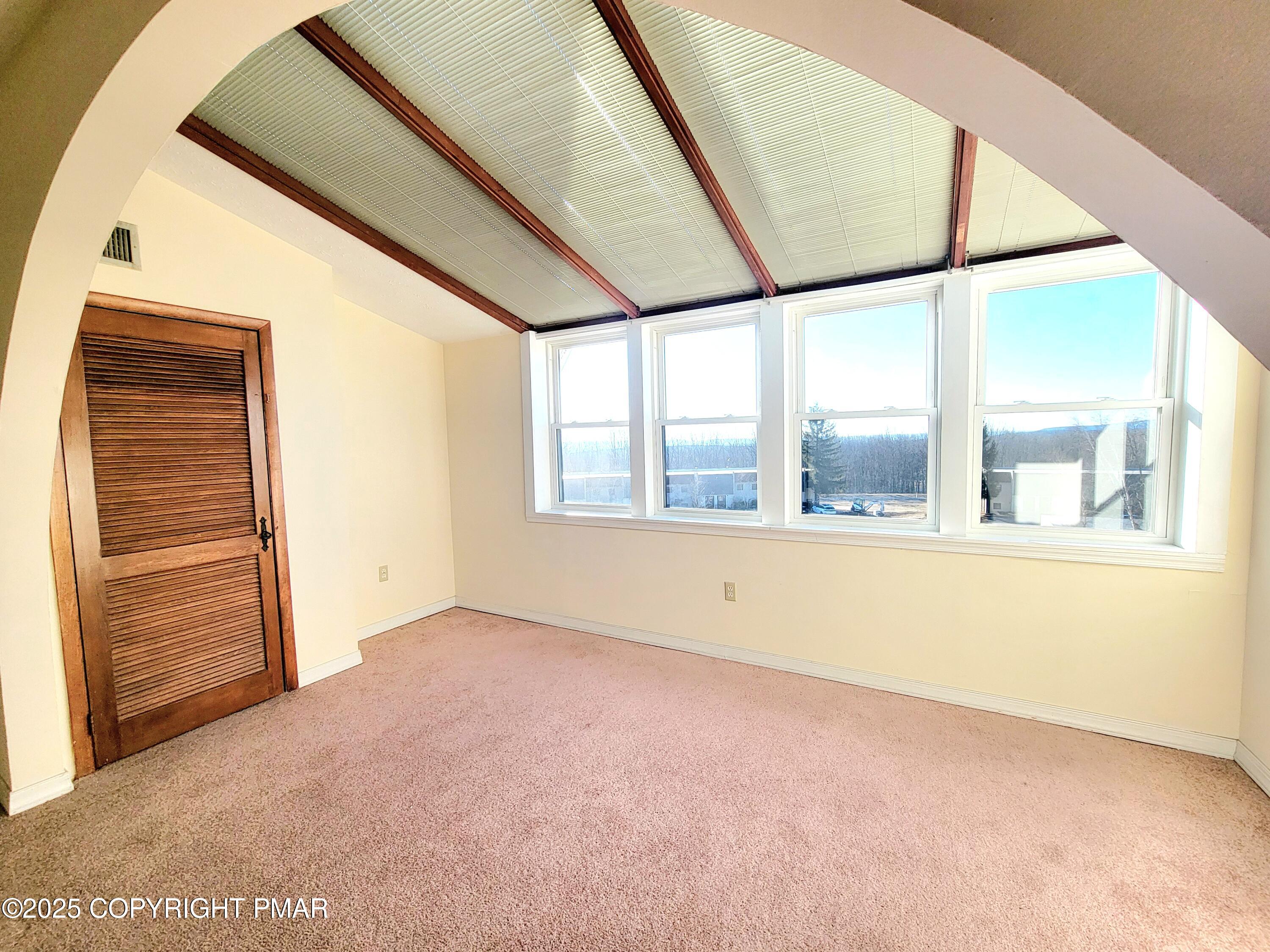 115 Foxfire Drive, Unit 306 Mount Pocono, PA 18344 - Photo 9 of 19 a view of an empty room with a window