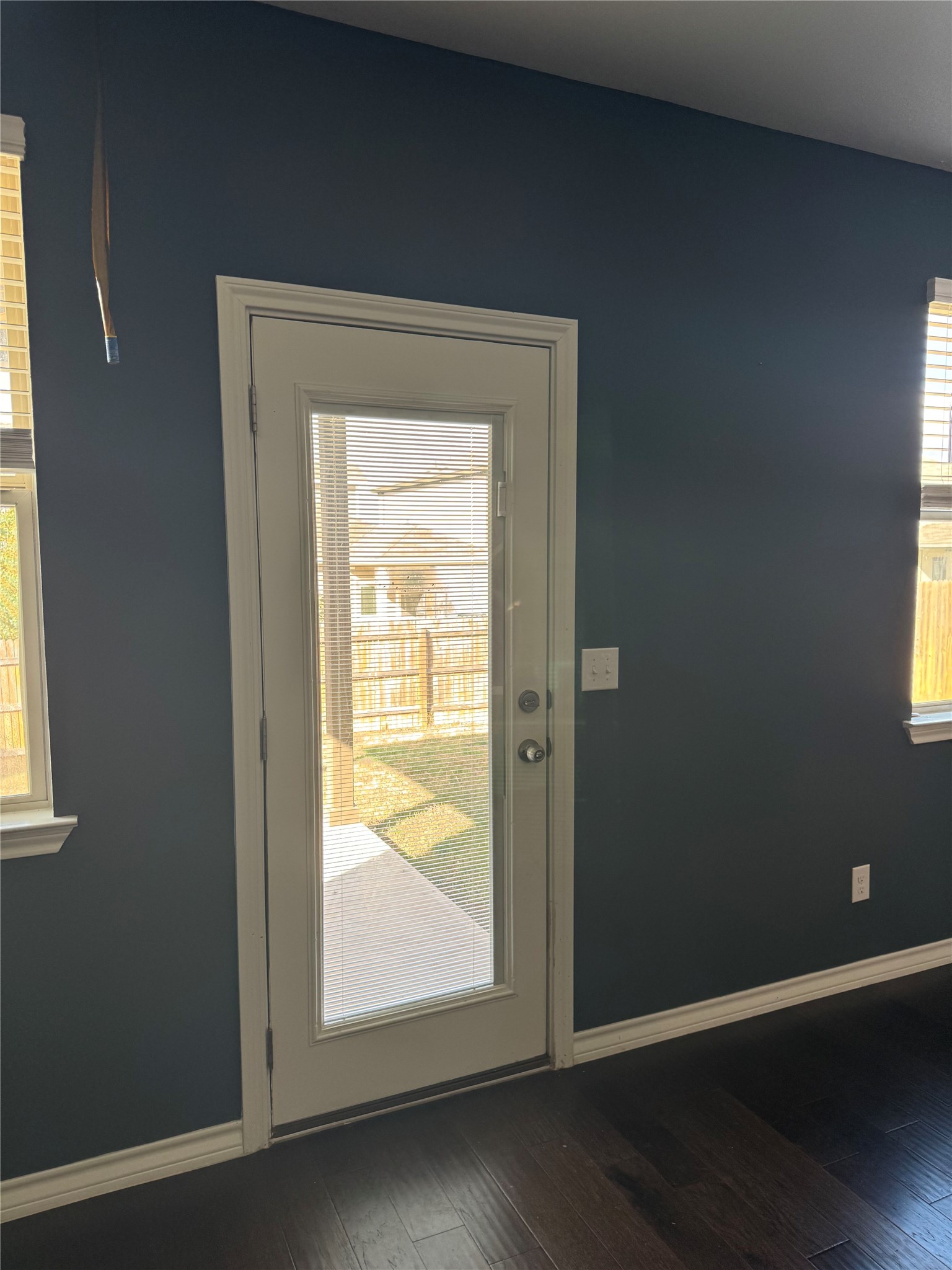 333 Capstone Road Liberty Hill, TX 78642 - Photo 19 of 40 Doorway to outside featuring baseboards and hardwood / wood-style flooring