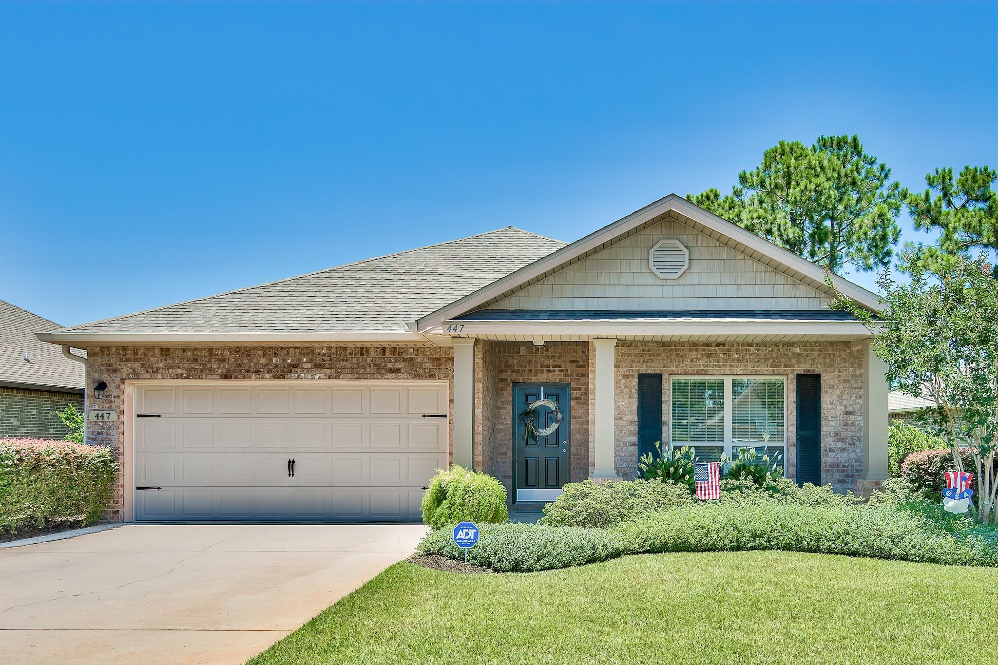 447 Pin Oak Loop Santa Rosa Beach, FL 32459 - Photo 1 of 46 a front view of a house with garden
