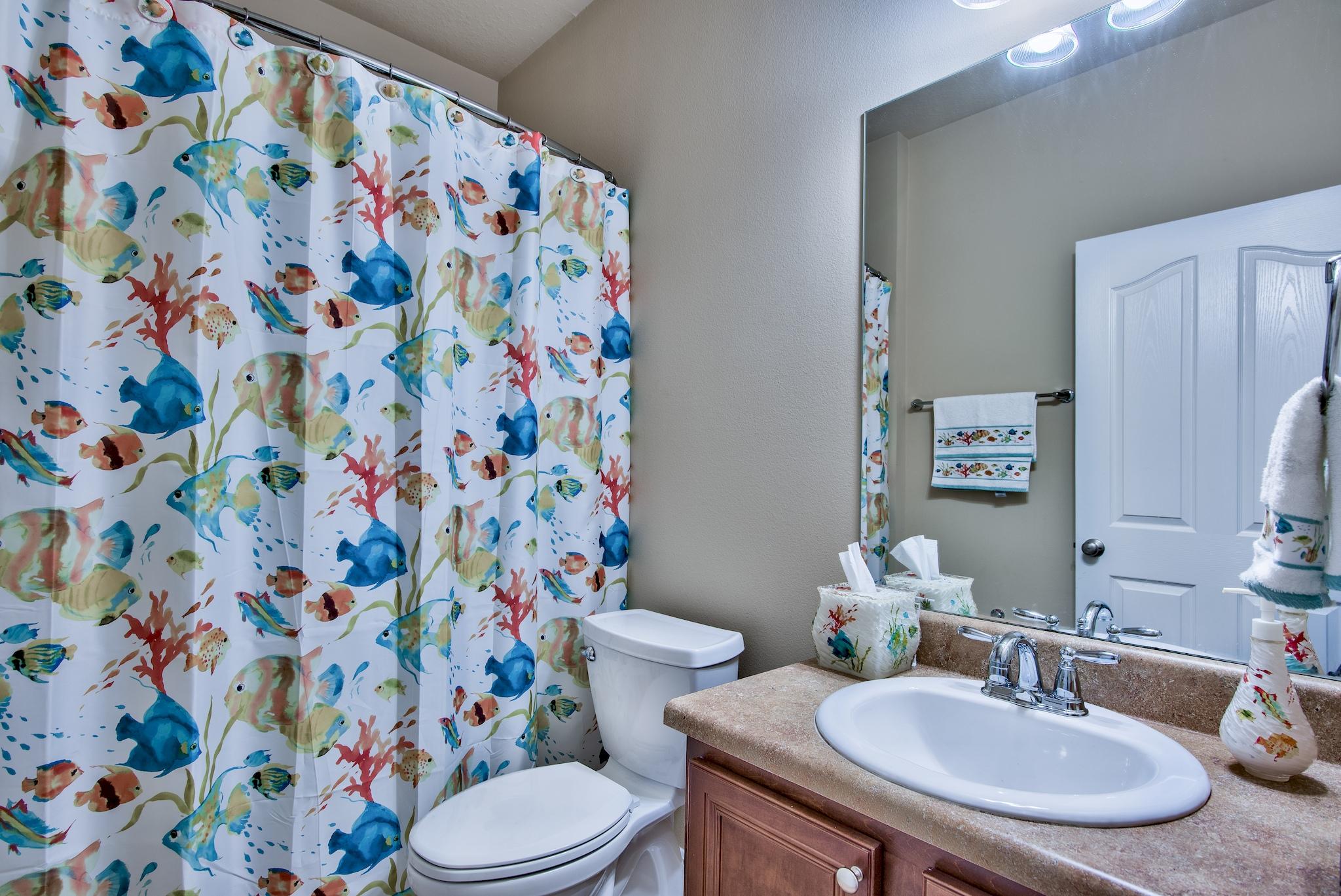 447 Pin Oak Loop Santa Rosa Beach, FL 32459 - Photo 20 of 46 a bathroom with a sink and mirror with toilet
