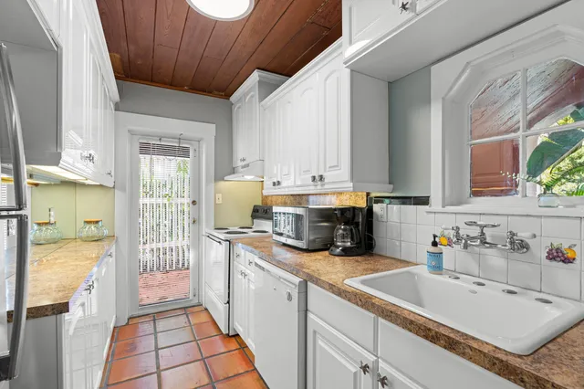 a kitchen with a sink stove and cabinets