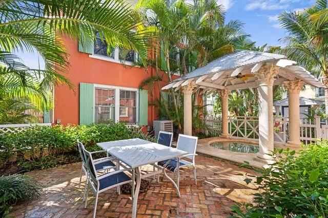 a view of a patio with table and chairs and potted plants