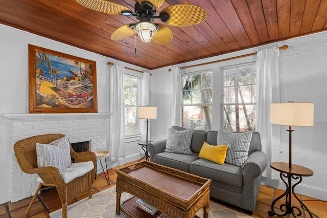 a living room with furniture a ceiling fan and a rug