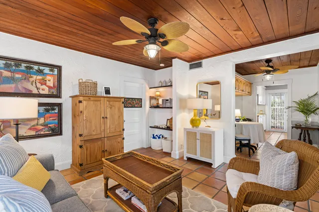 a living room with furniture and kitchen view
