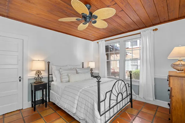 a bed room with a bed and a ceiling fan