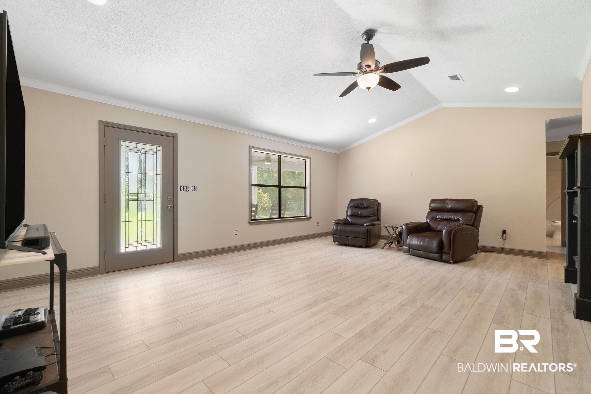 27300 C R Watson Road Robertsdale, AL 36567 - Photo 6 of 35 Sitting room featuring lofted ceiling, ceiling fan, light hardwood / wood-style flooring, ornamental molding, and a textured ceiling