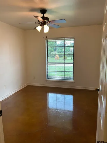 a view of an empty room with a fan