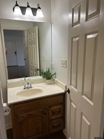 a white toilet and tub sitting next to a bathroom sink