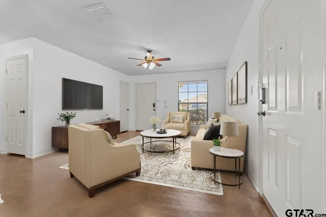 a living room with furniture and a flat screen tv