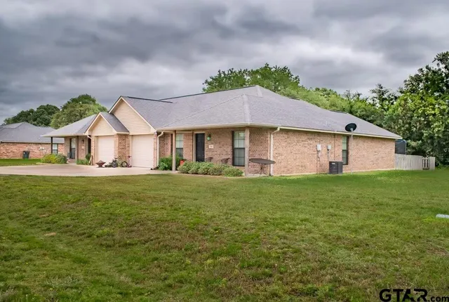 a front view of house with yard and green space