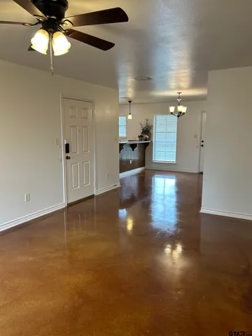 an empty room with wooden floor and cabinet