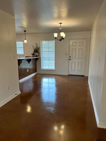 a kitchen with stainless steel appliances kitchen island granite countertop a stove a sink and a wooden floors