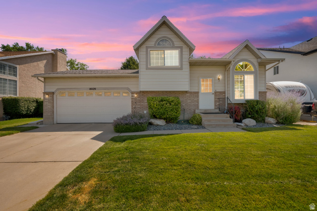 8029 Angel Street Sandy, UT 84070 - Photo 17 of 21 Split-level exterior featuring light-colored siding and brick accents