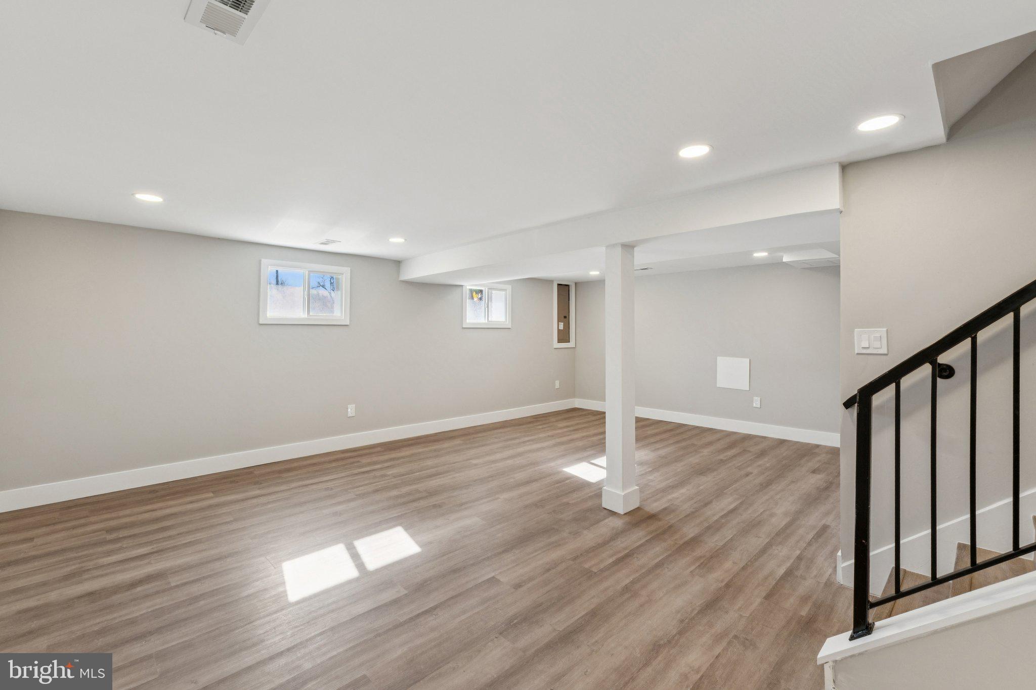 10101 Greeley Avenue Silver Spring, MD 20902 - Photo 17 of 25 a view of an empty room with wooden floor and staircase
