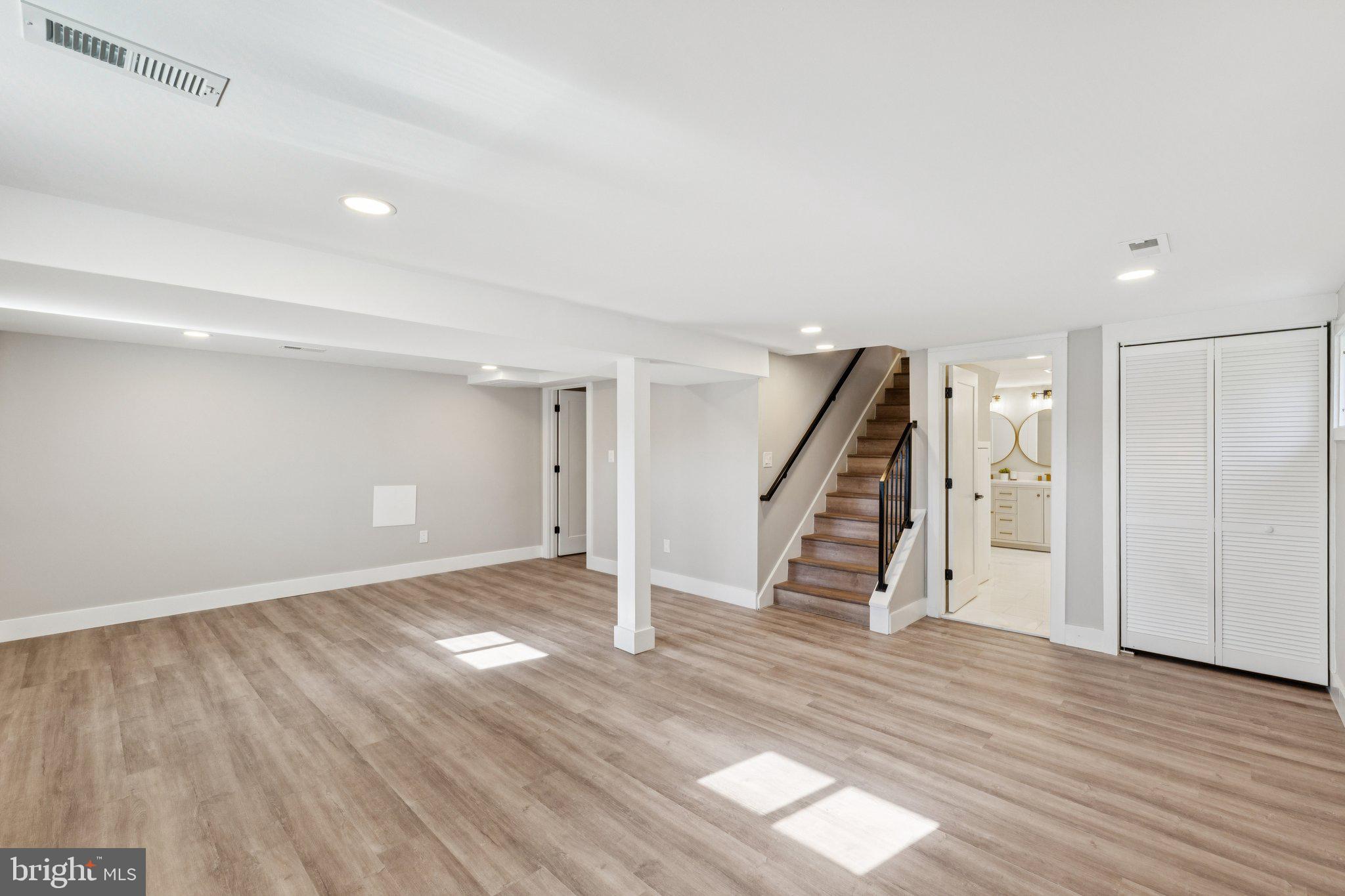 10101 Greeley Avenue Silver Spring, MD 20902 - Photo 18 of 25 a view of empty room with wooden floor and stairs