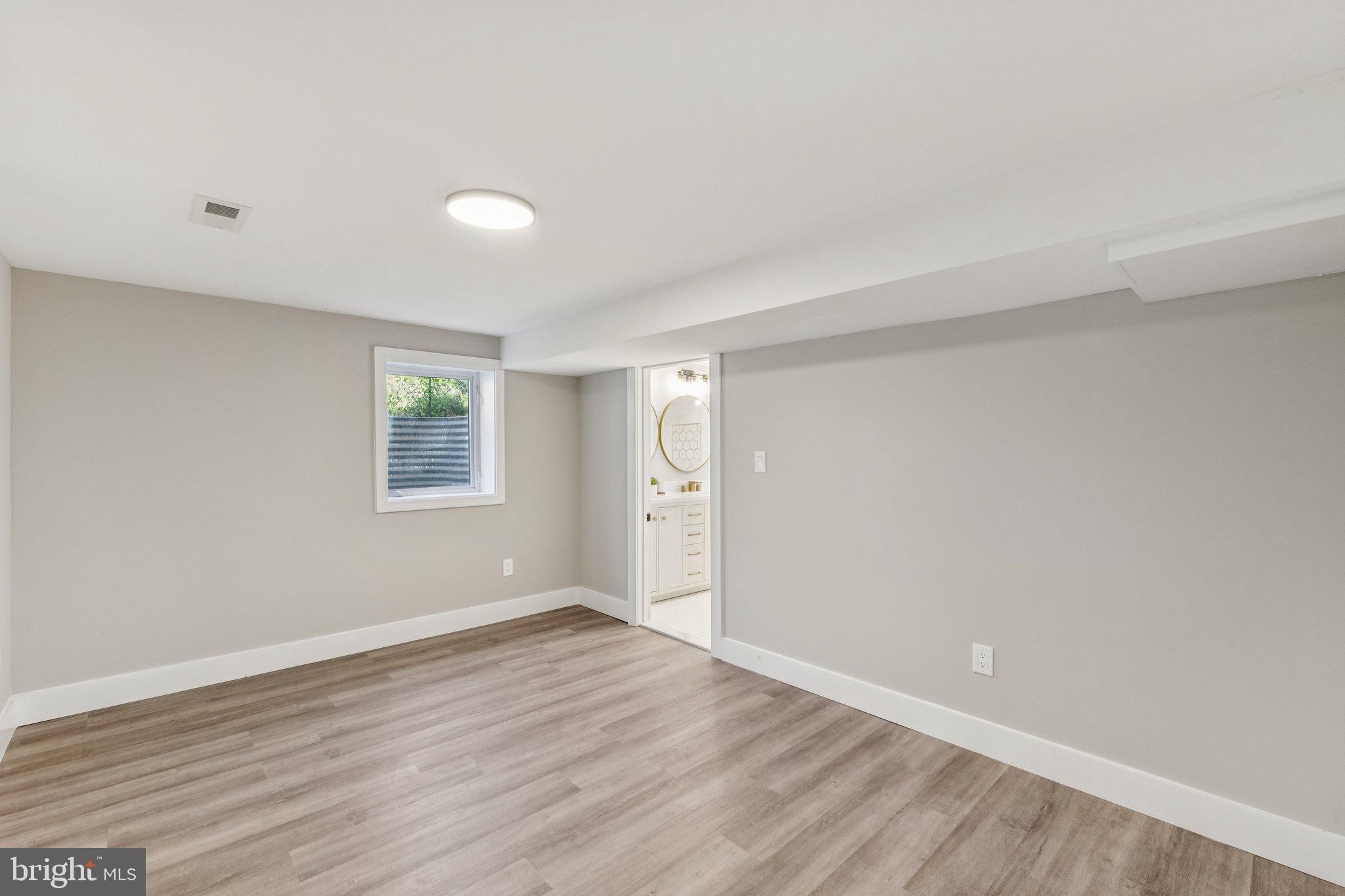 10101 Greeley Avenue Silver Spring, MD 20902 - Photo 19 of 25 an empty room with wooden floor and windows