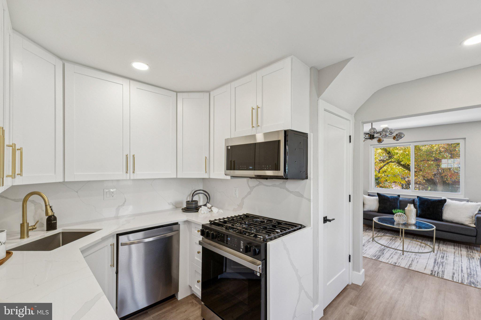 10101 Greeley Avenue Silver Spring, MD 20902 - Photo 5 of 25 a kitchen with stainless steel appliances granite countertop a stove and a sink