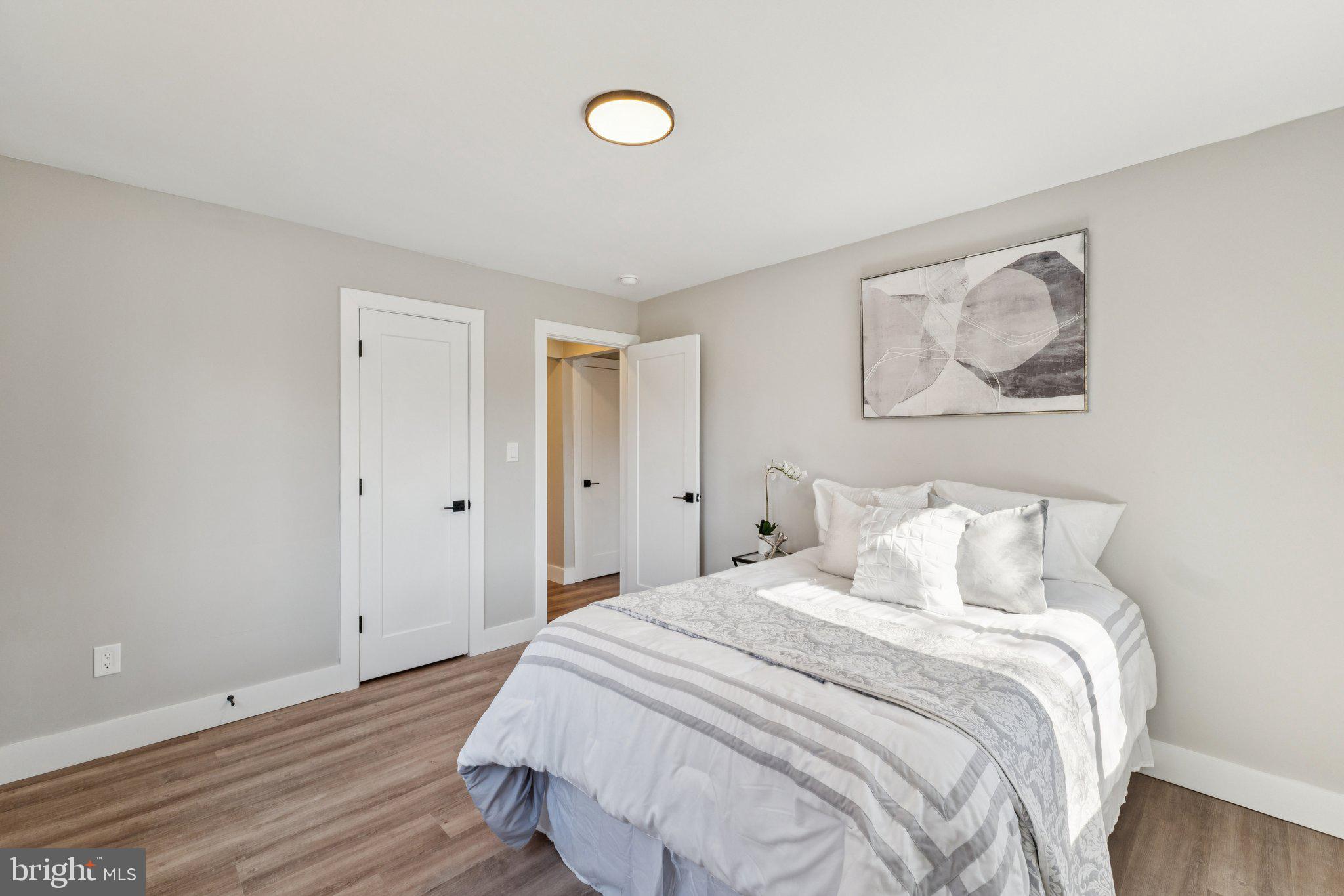 10101 Greeley Avenue Silver Spring, MD 20902 - Photo 8 of 25 a bedroom with a bed and painting on the wall