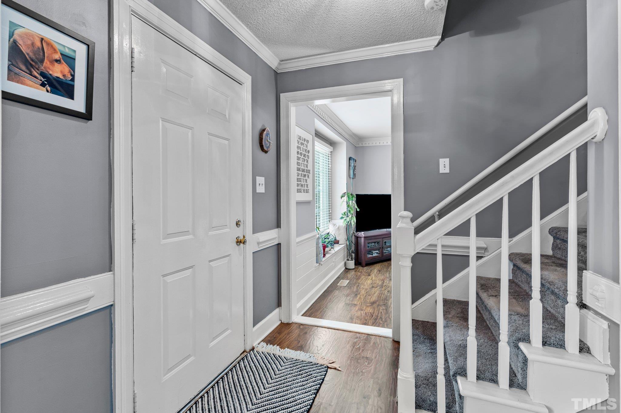 6212 Wynbrook Way Raleigh, NC 27612 - Photo 15 of 45 a view of entryway with wooden floor and stairs