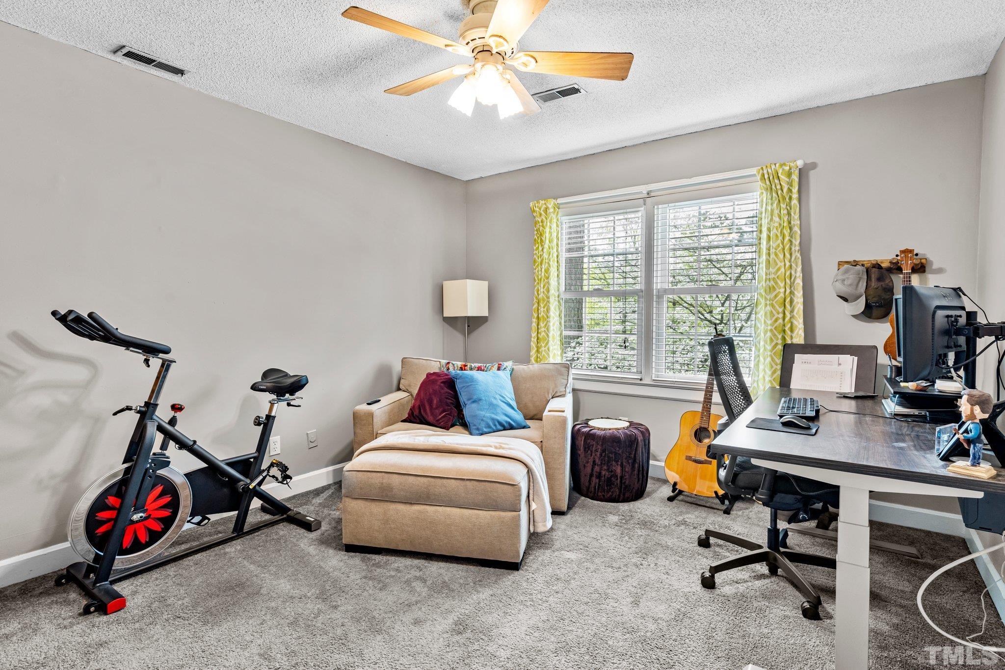 6212 Wynbrook Way Raleigh, NC 27612 - Photo 24 of 45 a living room with furniture a flat screen tv and a window