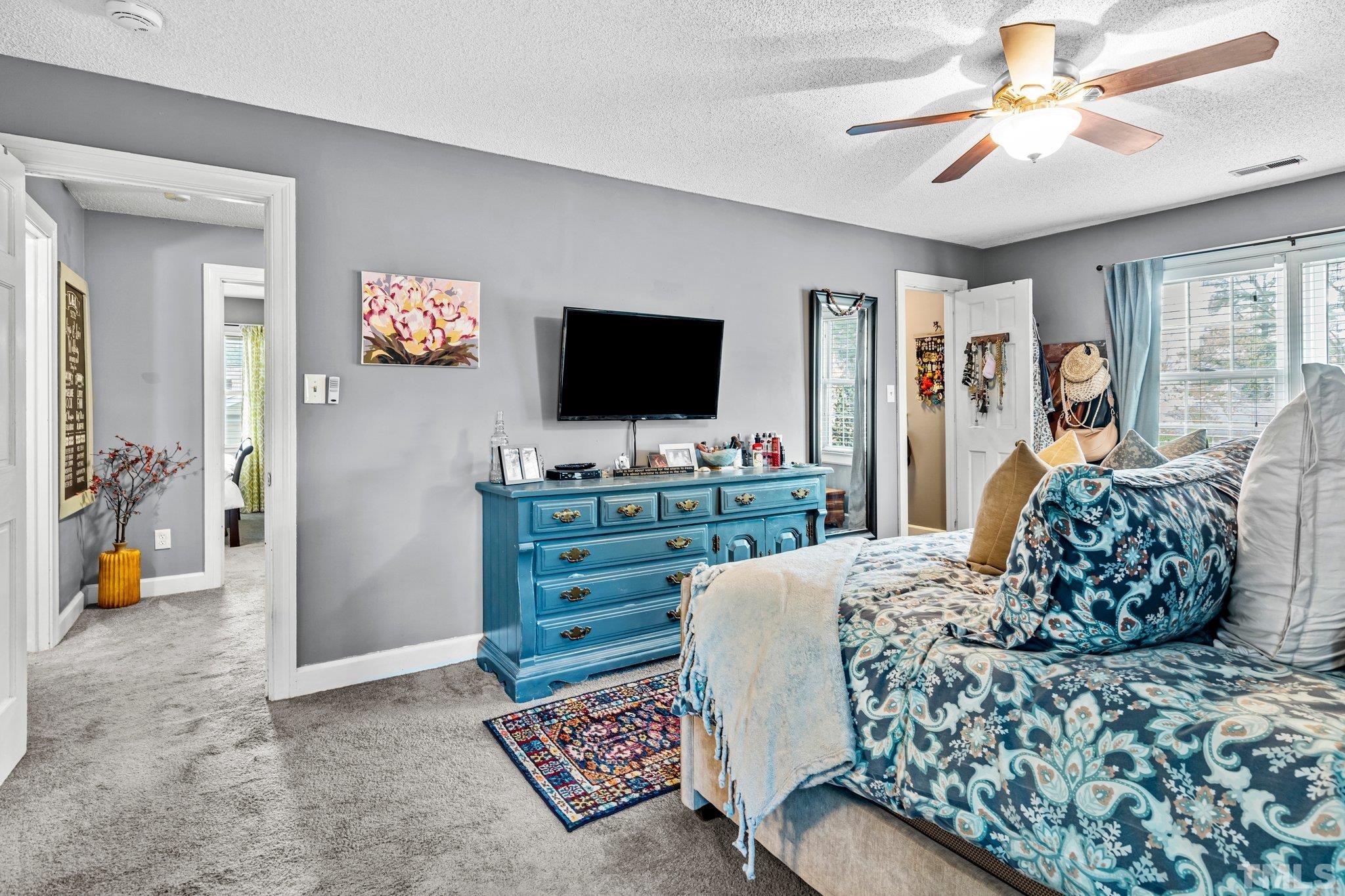 6212 Wynbrook Way Raleigh, NC 27612 - Photo 28 of 45 a living room with furniture and a flat screen tv