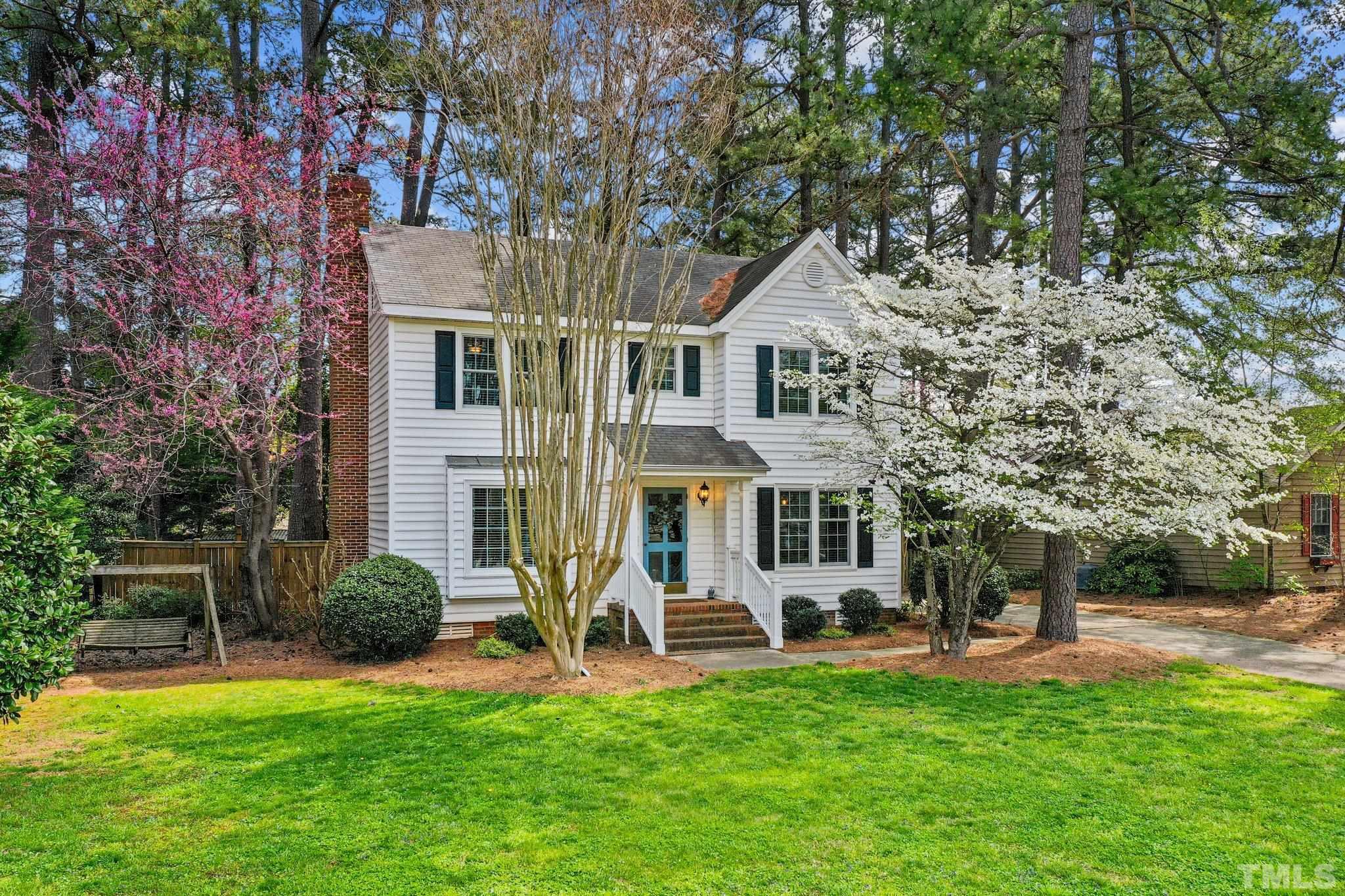 6212 Wynbrook Way Raleigh, NC 27612 - Photo 3 of 45 a front view of a house with a garden and plants