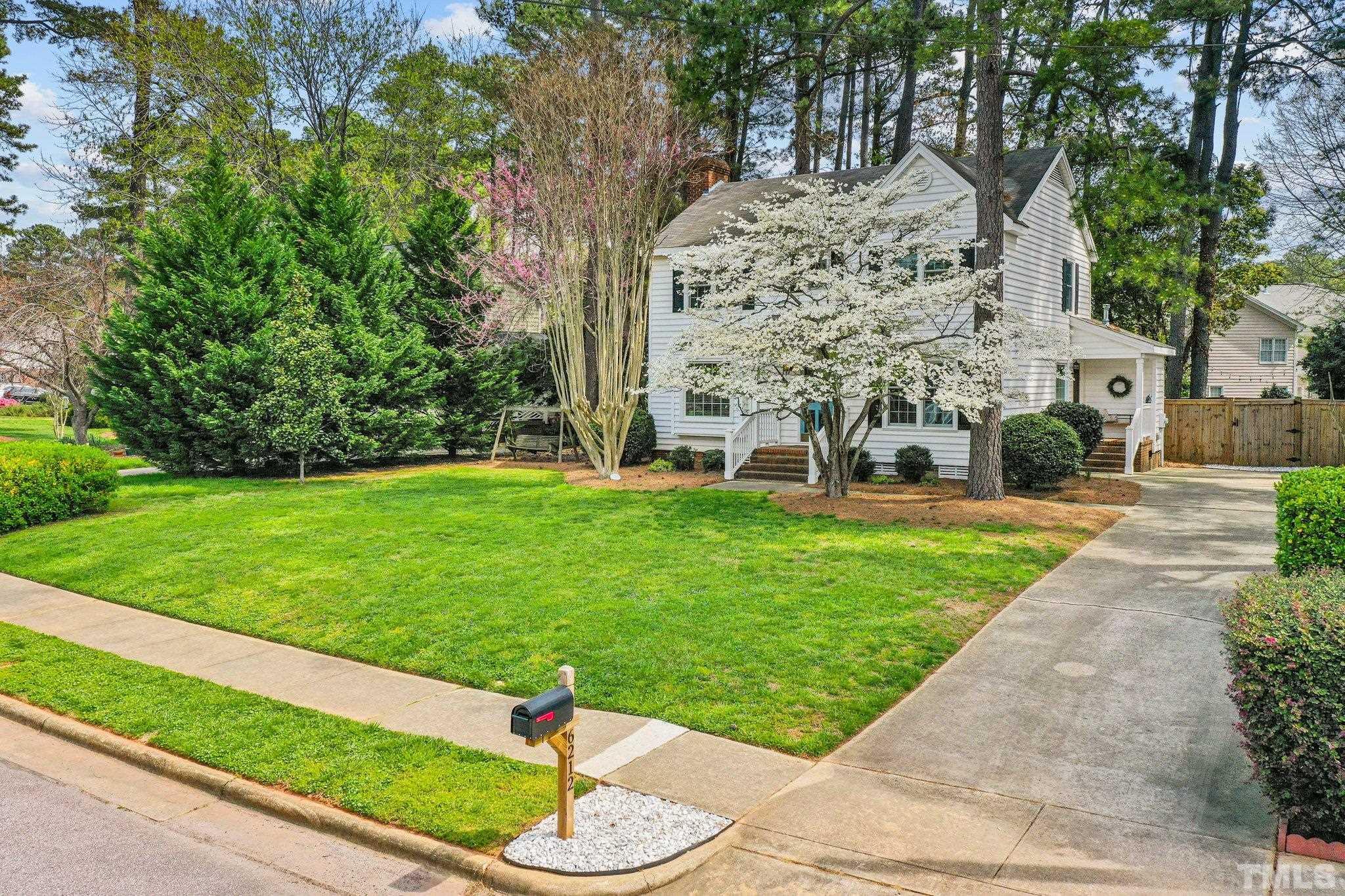 6212 Wynbrook Way Raleigh, NC 27612 - Photo 4 of 45 a garden with trees in the background