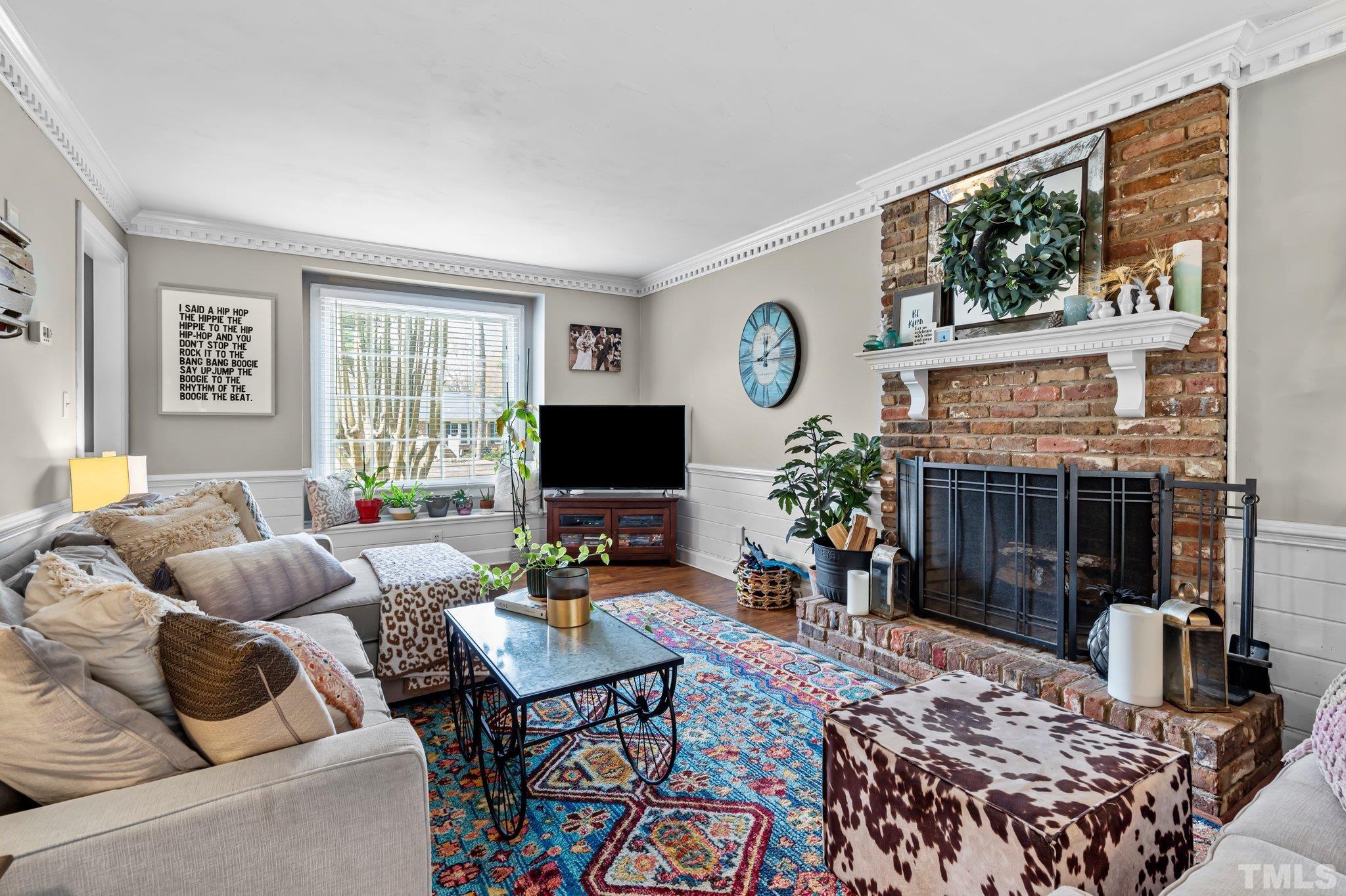 6212 Wynbrook Way Raleigh, NC 27612 - Photo 10 of 45 a living room with furniture a large window and a flat screen tv