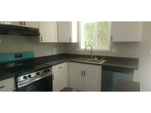 a kitchen with a sink cabinets and window